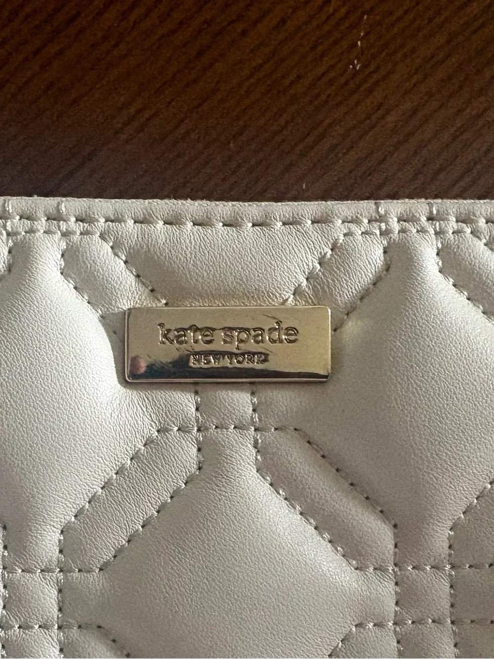 kate spade Cream Quilted Wristlet Clutch with Gold Logo